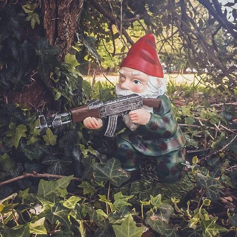 Close-up army garden gnomes aiming — detailed resin camouflage figurines