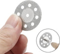 Hand holding 22mm diamond cutting disc showing size