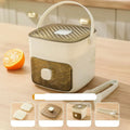 Ice cube maker in use with orange juice summer drinks