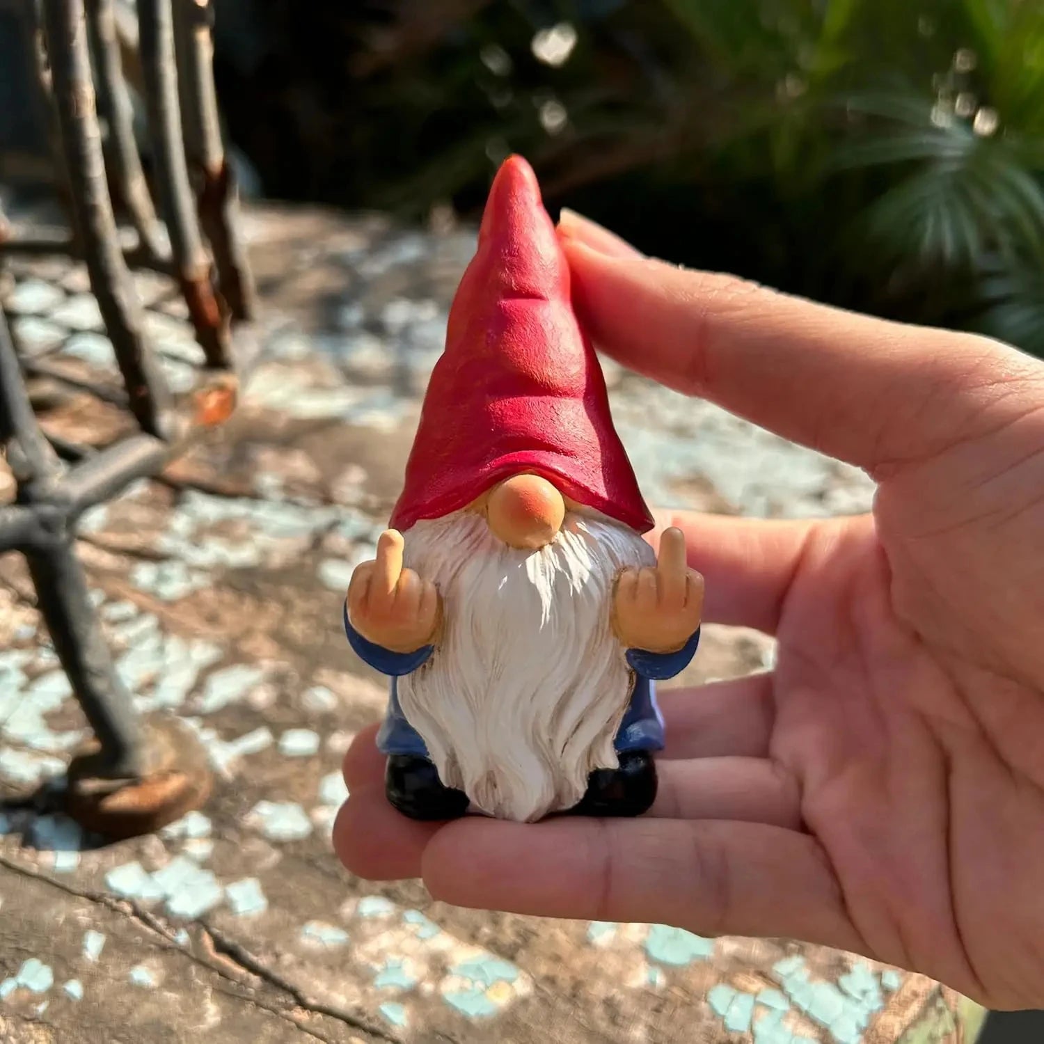 Close-up detail of naughty gnome figurine hand-painted retro design
