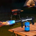 High power propane torch firing blue flame at BBQ camping outdoor night