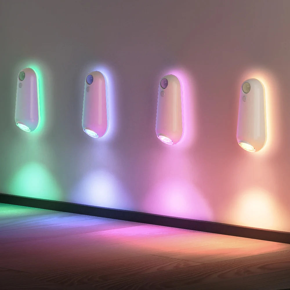 RGB motion sensor night light displaying multiple colors on wall